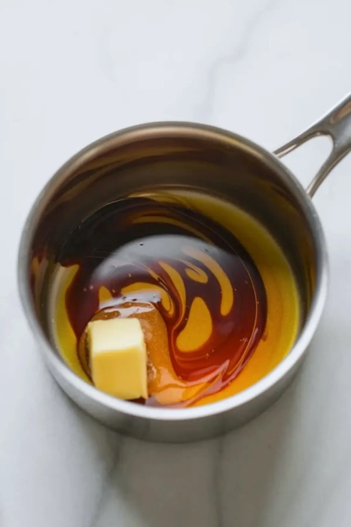 Butter and syrup in a saucepan at the start of the praline crunch caramel glaze