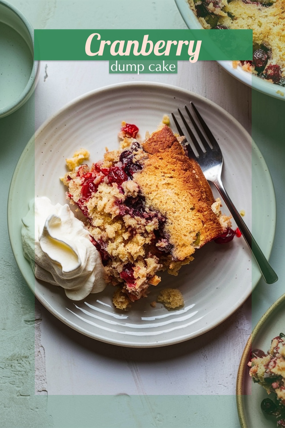 A slice of white chocolate cranberry dump cake served on a light plate with a dollop of whipped cream, showcasing a golden crust and a burst of vibrant cranberries