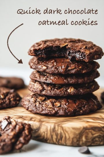A stack of fudgy oatmeal cookies filled with melted chocolate, showcasing a bite revealing the soft, decadent center.