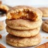 caramel stuffed cookies with caramel in the middle stacked on three rows