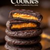 Stack of chocolate cookies with a bright pumpkin filling, topped with a chocolate glaze. The top cookie is split open, showing the vibrant orange filling inside.