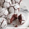 A batch of rich chocolate crinkle cookies with crackled powdered sugar tops, revealing a fudgy, gooey center.