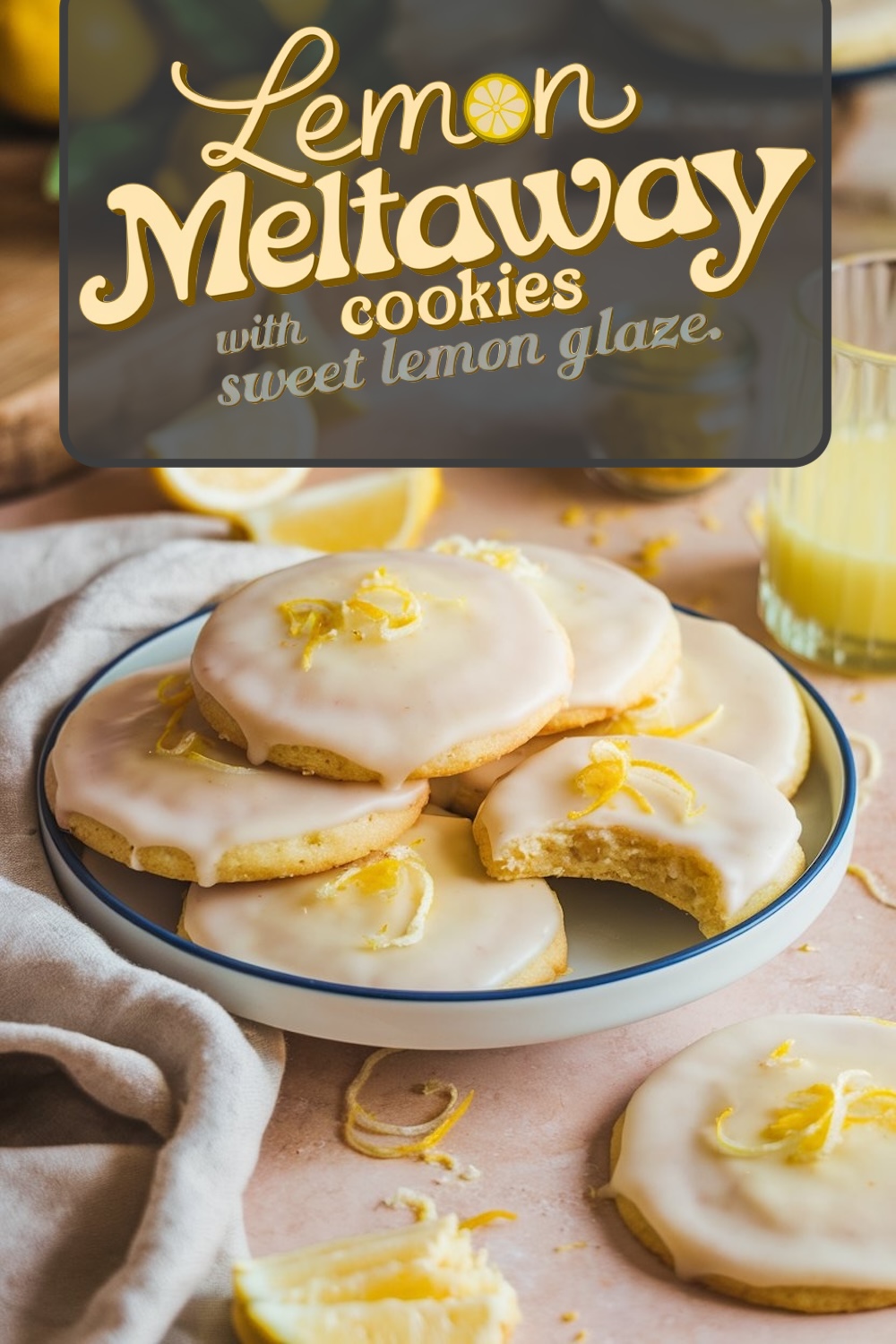Close-up of lemon meltaway cookies on a plate, covered in lemon glaze and garnished with lemon zest, showing a light, tender cookie with a bite taken out.