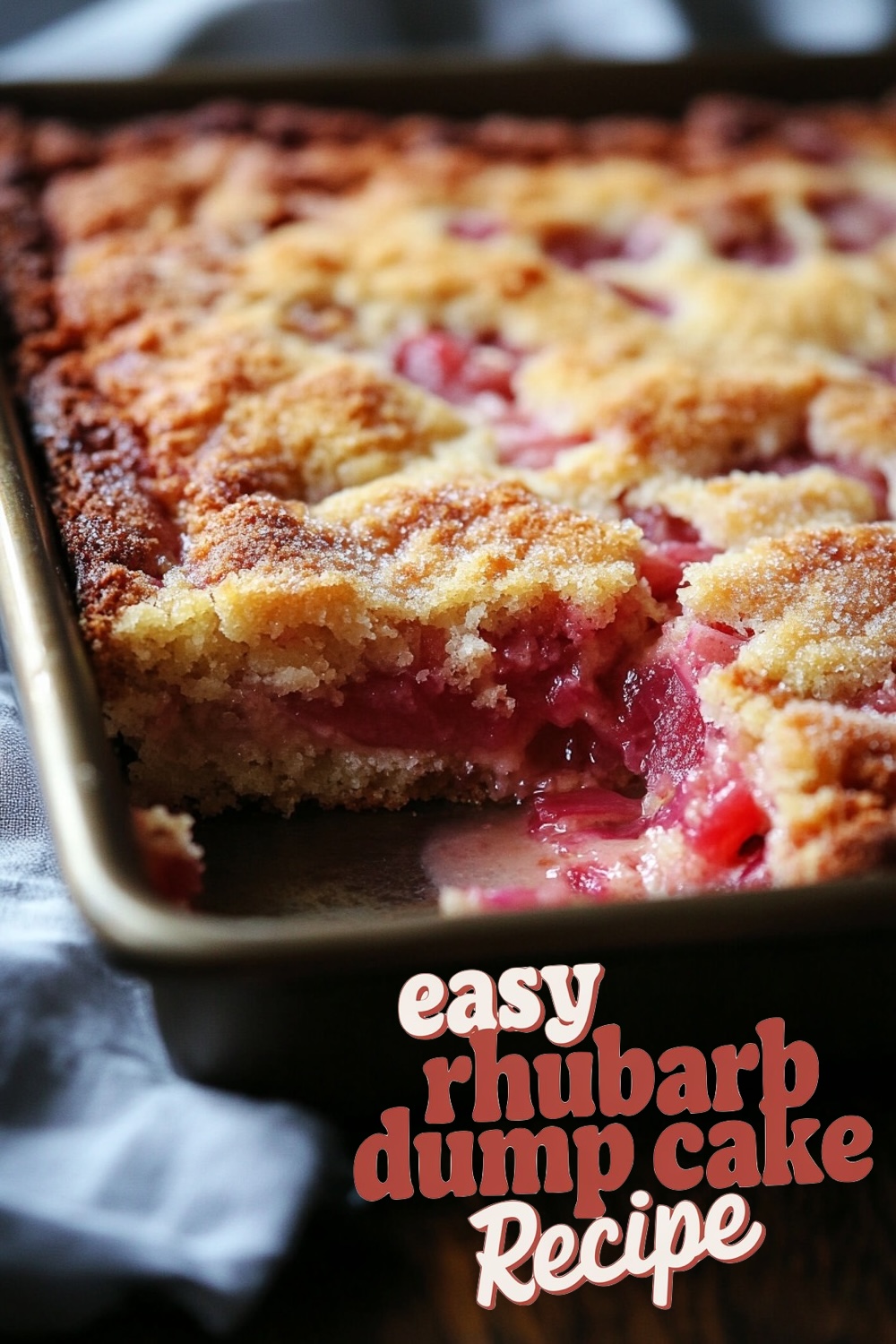 A baking pan filled with freshly baked rhubarb dump cake showcasing a golden brown top and pink rhubarb chunks visible, with text overlay 'easy rhubarb dump cake Recipe'.