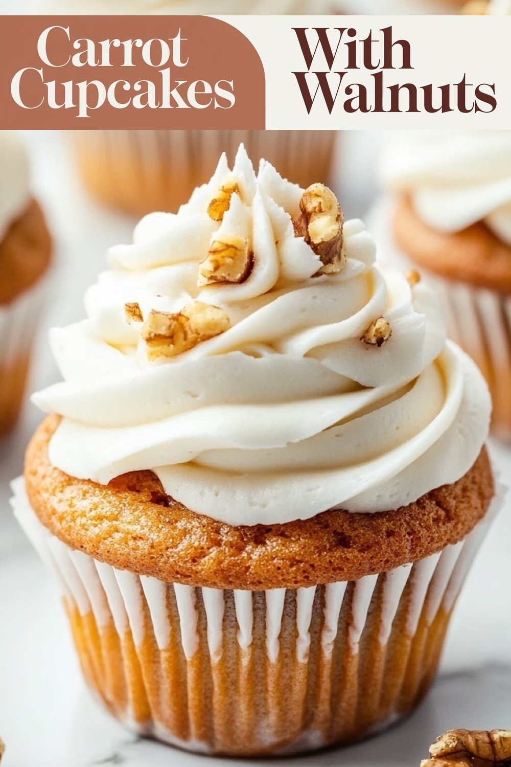 Carrot walnut cupcakes with cream cheese frosting, topped with a sprinkle of chopped walnuts and cinnamon, displayed on a white surface with walnuts scattered around.