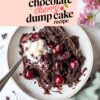 A top-down view of a plate featuring a decadent chocolate cherry dump cake topped with vanilla ice cream. Rich chocolate crumbles and juicy cherries are scattered around the plate, accompanied by pink flowers in the background. The text overlay reads "Easy Chocolate Cherry Dump Cake Recipe.