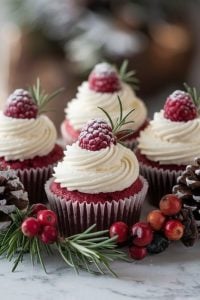 Festive Red Velvet Cupcakes with Creamy Vanilla Frosting and Fresh Raspberries – 24 Days of Christmas Desserts: Gorgeous red velvet cupcakes with creamy vanilla frosting, highlighted in "24 Days of Christmas Desserts." Topped with frosted raspberries and rosemary sprigs, these cupcakes are a perfect blend of festive elegance and rustic winter charm, surrounded by pinecones and cranberries for a holiday-ready presentation.