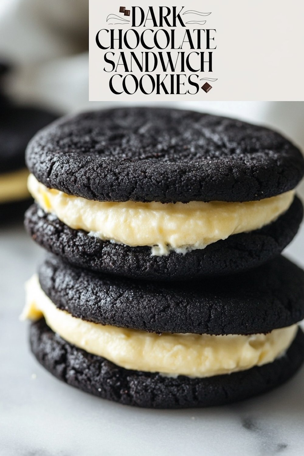 A stack of dark chocolate sandwich cookies filled with a thick layer of vanilla cream, prominently displayed with the text 'Dark Chocolate Sandwich Cookies'.