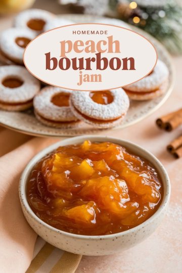 A visually appealing display of homemade peach bourbon jam accompanied by sugar-dusted donuts, arranged elegantly on a ceramic plate against a festive backdrop.