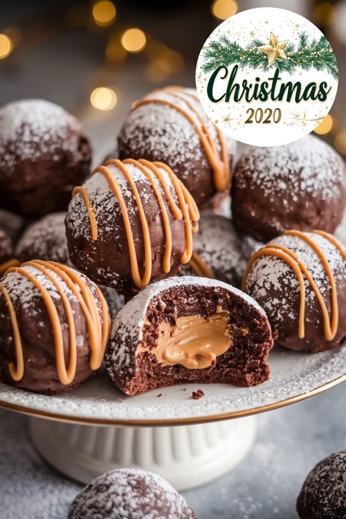 A close-up of chocolate peanut butter snowballs dusted with powdered sugar, highlighted by a neat drizzle of caramel on top. A bitten snowball reveals the smooth peanut butter filling. A "Christmas 2020" sign and soft holiday lighting enhance the cozy feel.