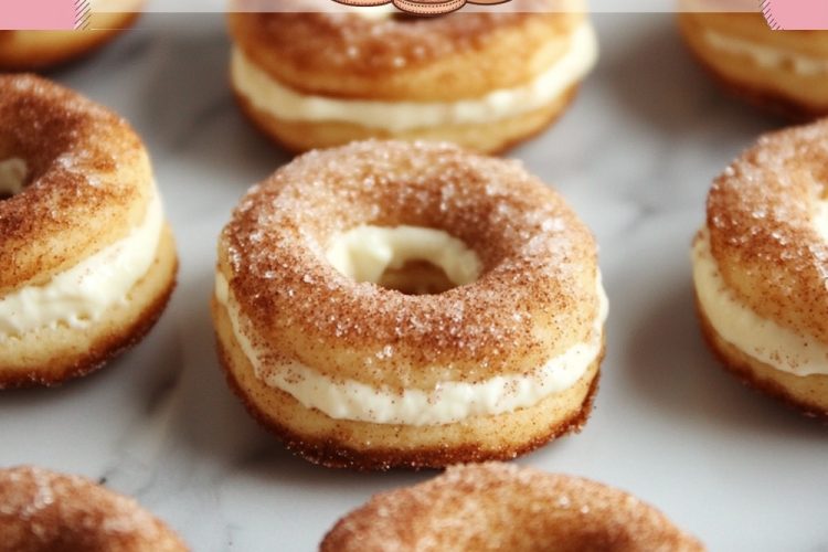 A batch of cinnamon cheesecake donuts neatly arranged, showcasing their golden texture and creamy filling in the middle.