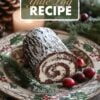 A classic Yule log cake on a decorative Christmas plate, featuring a rich chocolate spiral filled with cream, accompanied by festive berries and greenery.