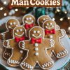 Cheerful display of classic gingerbread man cookies with white icing details and red fondant bow ties. These adorable cookies feature smiling faces and are arranged on a white plate against a festive holiday backdrop with twinkling lights, perfect for Christmas dessert spreads.