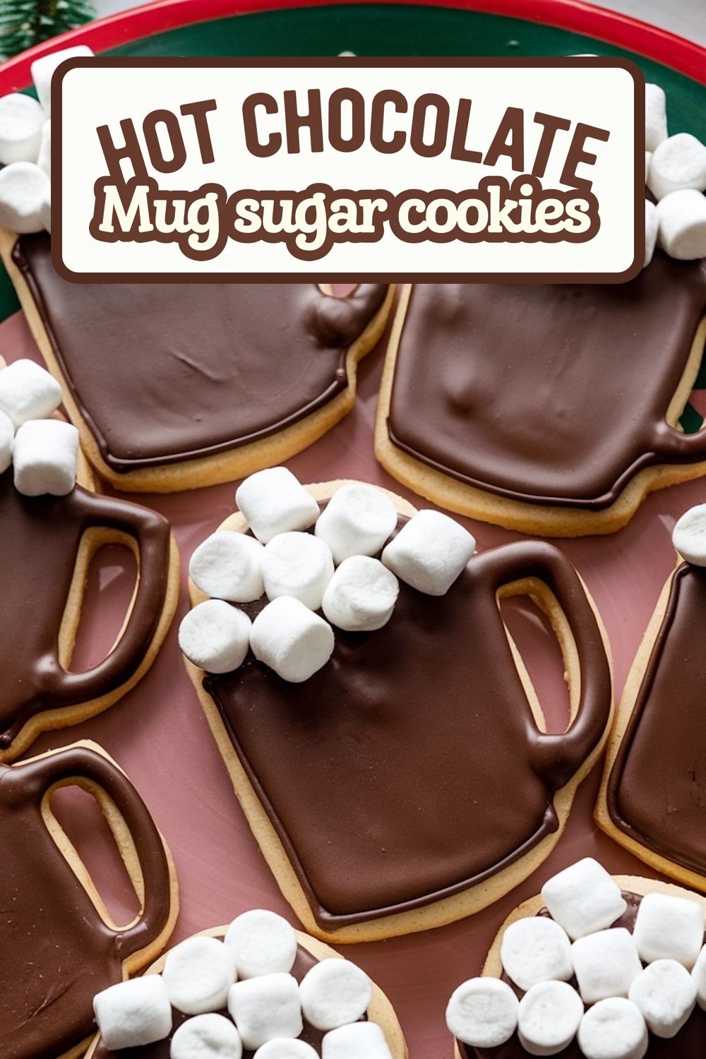 Festive "Hot Chocolate Mug" sugar cookies decorated with rich chocolate icing and topped with mini marshmallows to resemble a cozy cup of hot cocoa. These adorable cookies are perfect for winter gatherings or holiday baking, arranged on a red tray that enhances their seasonal charm.