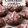 Close-up of freshly baked peppermint chocolate cookies topped with striped peppermint candies and sprinkled with crushed candy pieces, presented on a festive themed background.