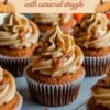 Festive display of Pumpkin Cupcakes with peanut butter frosting and caramel drizzle, set against a backdrop of autumn leaves and pumpkins, with the caption 'PUMPKIN CUPCAKES with caramel drizzle'.