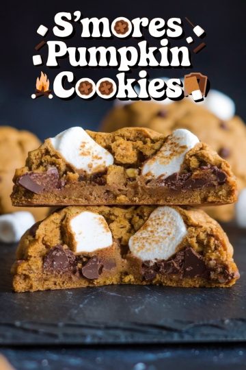 Close-up of a pumpkin s'mores cookie split in half, revealing gooey marshmallow, rich chocolate chunks, and soft pumpkin-flavored cookie dough.