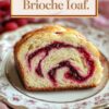 Close-up of a slice of Raspberry Swirl Brioche Loaf on a vintage floral plate, showcasing the intricate swirls of raspberry filling against the soft texture of the bread.