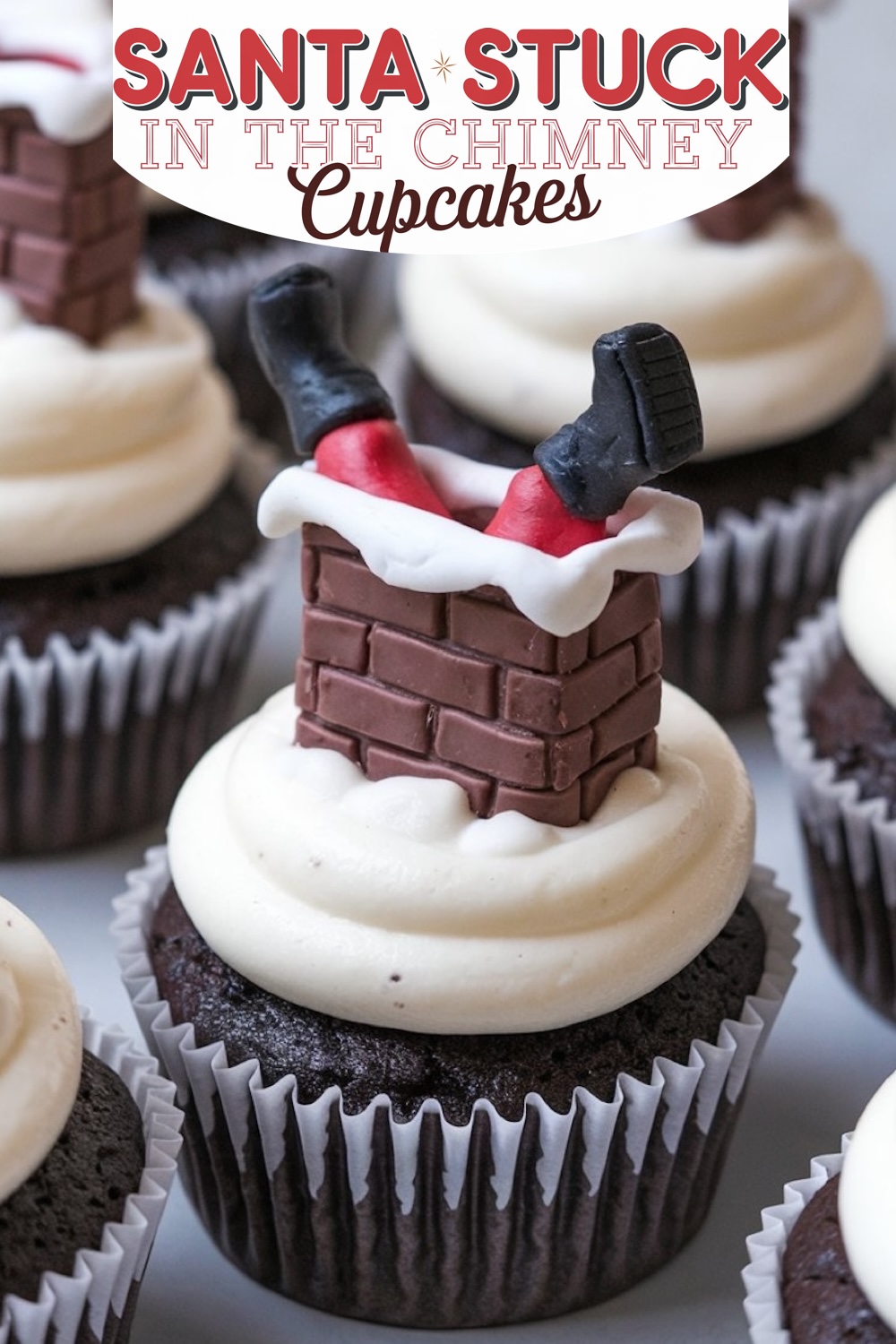 Christmas cupcake featuring a playful "Santa Stuck in the Chimney" design. A chocolate cupcake with smooth white buttercream frosting is topped with a fondant decoration resembling Santa's legs and black boots sticking out of a brick chimney, adding holiday cheer and whimsical charm to any dessert table