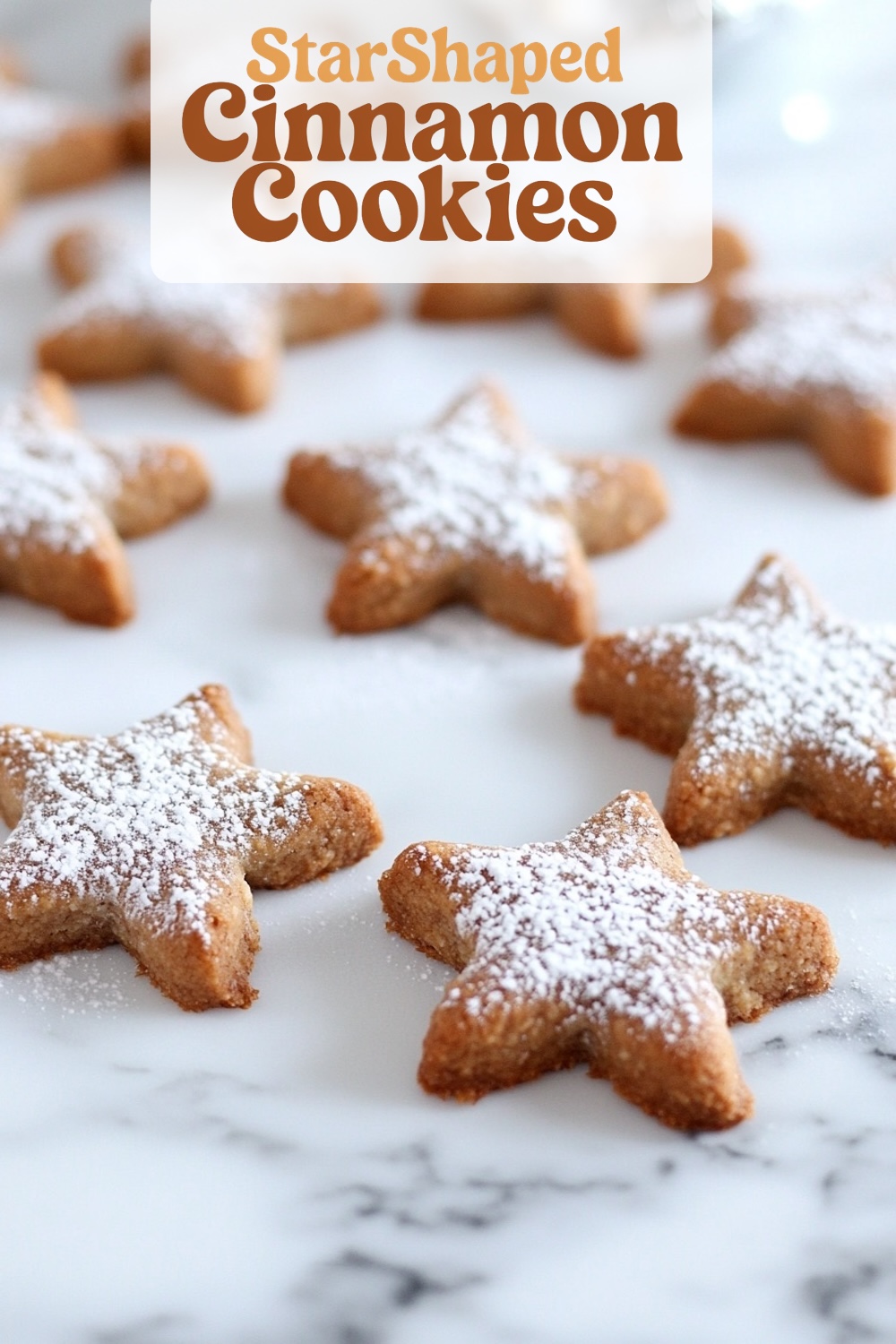 Zimtsterne, classic German star-shaped cinnamon cookies, dusted with powdered sugar on a marble surface.