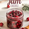 A cozy, homemade berry medley jam showcased in a clear glass jar, with vibrant red cranberries and other mixed berries suspended in the glossy jam. The wooden spoon beside the jar offers a closer view of the chunky texture, highlighting this rustic, seasonal recipe ideal for holiday spreads.
