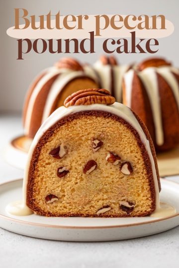 A close-up of a butter pecan pound cake with a tender crumb, studded with toasted pecans and topped with a glossy cream glaze. A whole pecan is placed on top for a perfect garnish. The text "Butter Pecan Pound Cake" is artfully displayed, emphasizing the dessert's homemade charm.