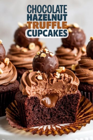 A mouthwatering display of chocolate hazelnut truffle cupcakes arranged on a plate. Each cupcake is topped with swirls of chocolate frosting, sprinkled with chopped hazelnuts, and adorned with a whole chocolate truffle. One cupcake has been cut in half, revealing the rich ganache center, creating an irresistible treat for special occasions or dessert tables.