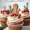 Close-up of a beautifully decorated gingerbread cupcake with cinnamon buttercream frosting. A smiling gingerbread man cookie sits atop a ring of juicy pomegranate arils, accented with rosemary sprigs, creating a festive and rustic holiday feel ideal for Christmas or winter-themed desserts.