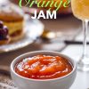 A beautifully styled breakfast scene featuring a bowl of orange jam on a table with pastries, fresh fruit, and a glass of orange juice. This orange jam is ideal for elevating any morning spread with a zesty, homemade touch.