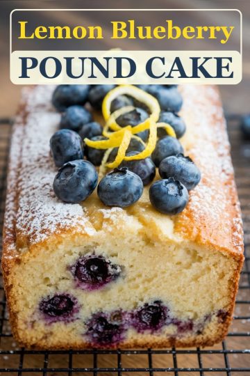A beautifully baked lemon blueberry pound cake topped with fresh blueberries, lemon zest curls, and a dusting of powdered sugar. A text overlay reads "Lemon Blueberry Pound Cake," capturing attention with a bold, inviting font and perfect for sharing this delicious dessert recipe online.