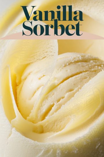 A close-up view of a single scoop of vanilla sorbet, revealing its smooth, creamy texture and subtle granules of ice. The soft, off-white hue and detailed texture give a mouthwatering appeal, highlighting the simplicity and freshness of homemade sorbet. This image captures the essence of minimalist dessert photography and is perfect for showcasing frozen treat recipes.