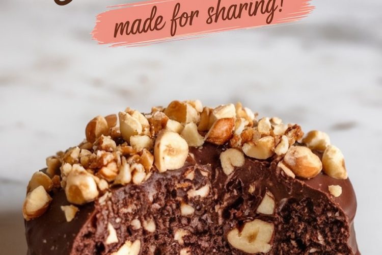 A close-up of a bitten chocolate hazelnut cookie on a marble surface, showcasing the fudgy interior, chocolate coating, and generous hazelnut topping, perfect for highlighting its decadent texture.