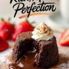 A molten chocolate lava cake on a plate, with a stream of rich chocolate flowing from the center. The dessert is topped with a swirl of whipped cream dusted with cocoa powder, surrounded by fresh strawberries. Text overlay reads “Rich, Molten Perfection.”