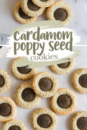 A top-down view of freshly baked cardamom poppy seed cookies arranged on a marble surface. The cookies have a golden-brown edge with a dark poppy seed center. A text overlay reads “cardamom poppy seed cookies.”