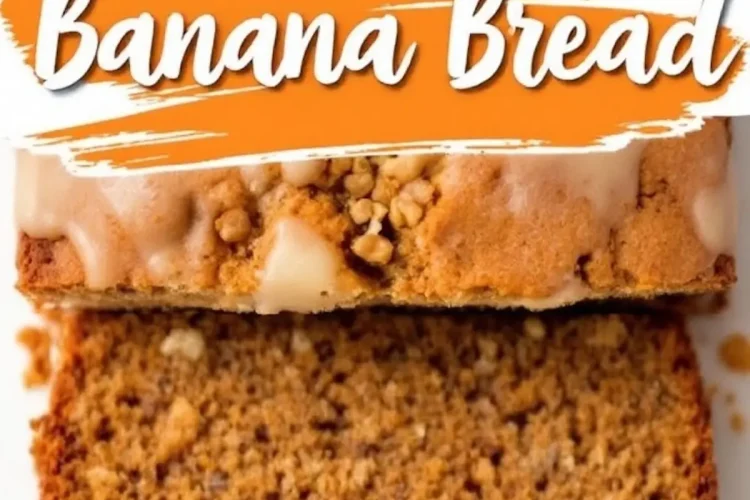 Close-up of a sliced carrot cake banana bread with a golden-brown crust, creamy glaze, and crunchy streusel topping. The inside reveals a moist, spiced crumb with visible flecks of nuts. Text overlay in blue and orange reads “Carrot Cake Banana Bread.”