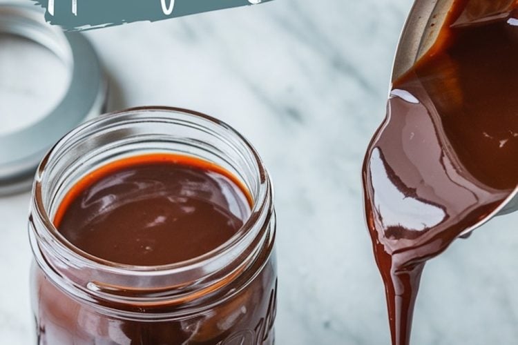 Close-up of a jar filled with rich, glossy homemade hot fudge sauce, next to a bowl being filled as the sauce is poured. Text overlay reads “Homemade Hot Fudge Sauce.”
