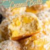 Close-up of pineapple coconut balls with one ball cut in half, showcasing the creamy interior with visible pineapple chunks. The balls are coated in shredded coconut and have a golden tropical appearance, perfect for highlighting their tropical-inspired flavors.