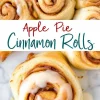A close-up of gooey apple pie cinnamon rolls with a thick icing drizzle. The golden-brown swirls are packed with cinnamon and apple filling. A text overlay in a modern script reads “Apple Pie Cinnamon Rolls.”