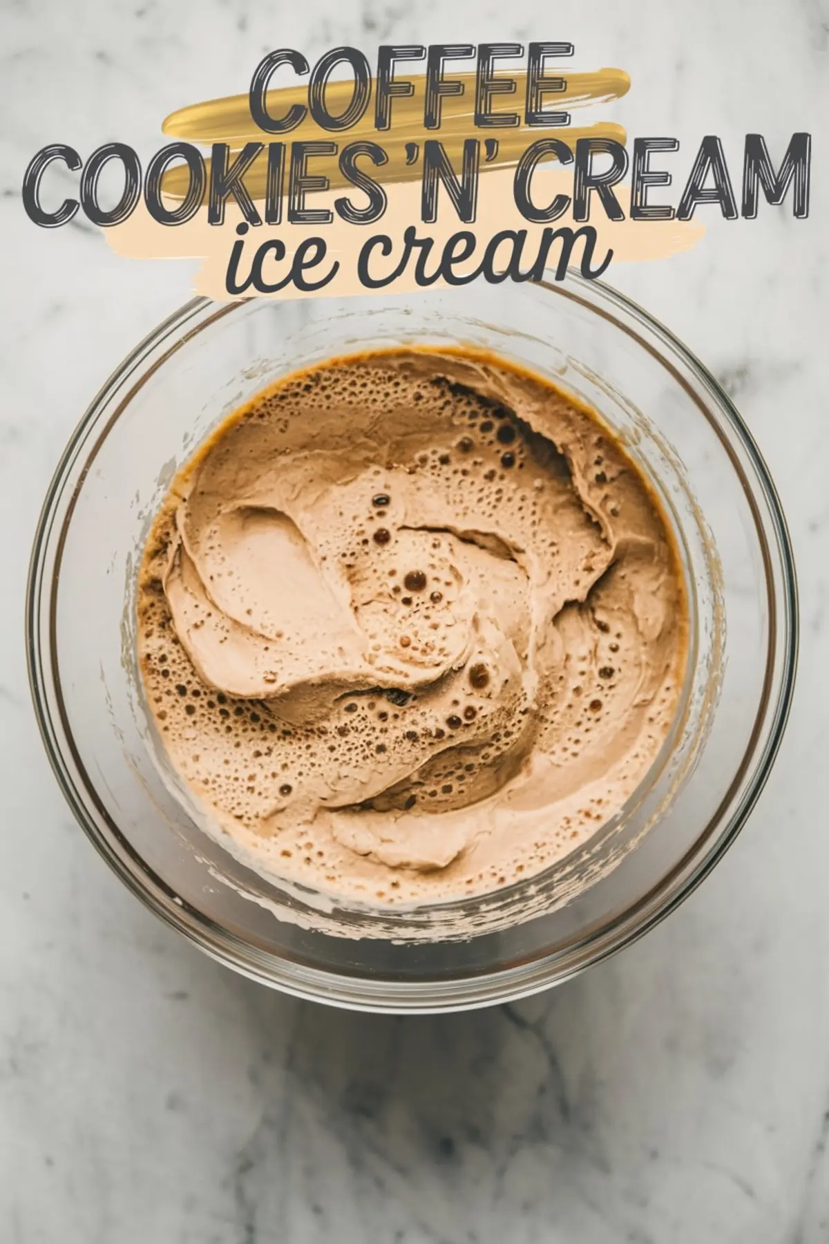 A glass bowl filled with freshly churned coffee cookies and cream ice cream. The texture appears airy and slightly melted, with visible bubbles on the surface. A text overlay at the top reads "Coffee Cookies 'n' Cream Ice Cream," complementing the homemade aesthetic.