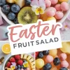 Close-up of an Easter fruit salad bowl with strawberries, blueberries, pineapple, kiwi slices, and pink yogurt-covered fruit balls, beautifully arranged with edible flowers. Collage features detailed views of the vibrant fruit medley and playful pastel accents.