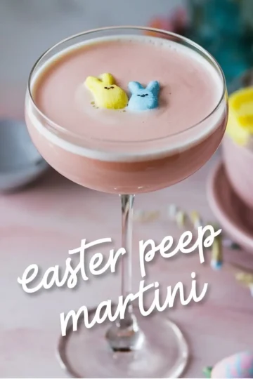 Pink Easter Peep martini in a coupe glass topped with yellow and blue bunny-shaped marshmallows. The pastel setting and festive decor enhance the whimsical, holiday-inspired presentation.