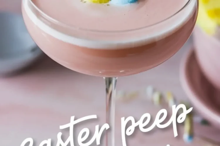 Pink Easter Peep martini in a coupe glass topped with yellow and blue bunny-shaped marshmallows. The pastel setting and festive decor enhance the whimsical, holiday-inspired presentation.