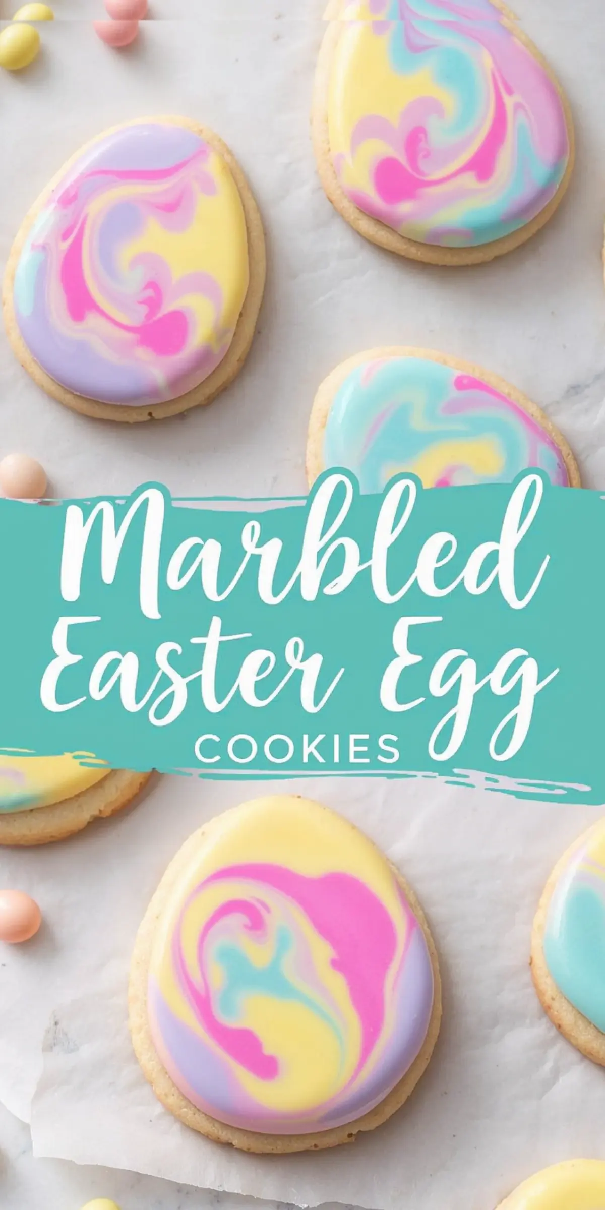 Several pastel marbled Easter egg cookies with smooth, glossy icing in pink, blue, yellow, and purple swirls. Small candy eggs are scattered around. A text overlay reads “Marbled Easter Egg Cookies.”