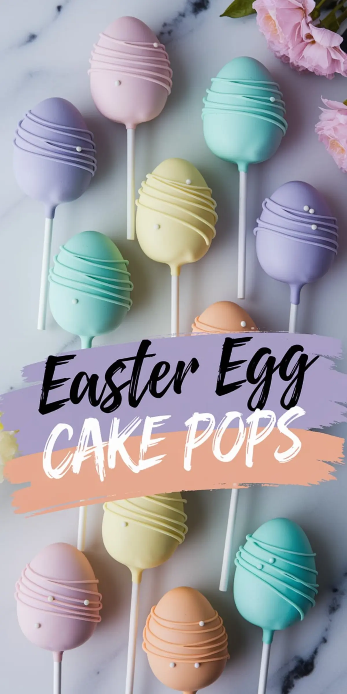 Assorted pastel Easter egg cake pops in shades of lavender, pink, mint green, yellow, teal, and peach, decorated with swirl patterns and tiny white sugar pearls, arranged on marble with pink flowers.
