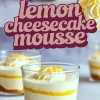 Close-up collage of lemon cheesecake mousse desserts in glass cups. The layers of graham cracker crust, creamy cheesecake mousse, and tangy lemon curd are clearly visible. Each dessert is topped with whipped cream and lemon zest. The words “lemon cheesecake mousse” are displayed in bold purple text.