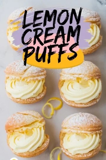 Six golden lemon cream puffs arranged on parchment with piped lemon filling and a light dusting of powdered sugar. Bright lemon zest curls add contrast to the crisp pastry shells, styled for a fresh, citrus-forward dessert visual.