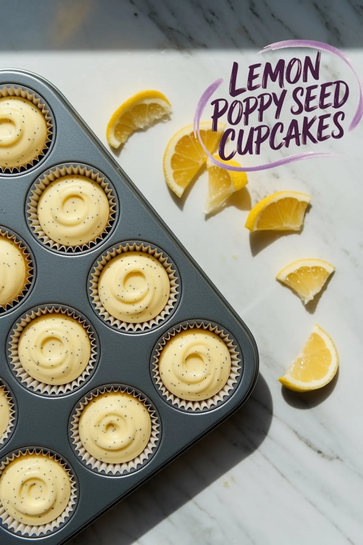 Overhead shot of a muffin tin filled with raw lemon poppy seed cupcake batter, swirled in each liner. Lemon wedges are scattered around, and a text overlay reads “LEMON POPPY SEED CUPCAKES.”
