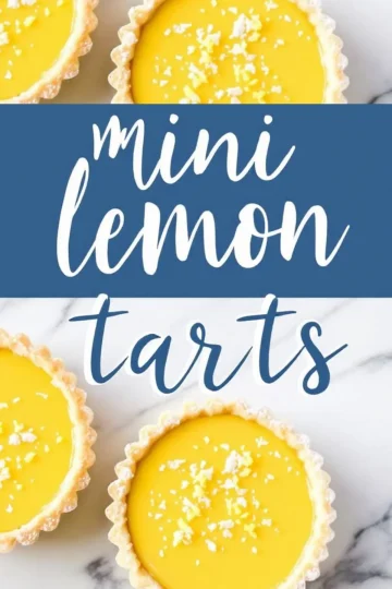 Overhead shot of two mini lemon tarts on a marble surface, each with a golden, flaky crust and a bright yellow filling. The tarts are sprinkled with powdered sugar and lemon zest. A bold blue text overlay reads “Mini Lemon Tarts.”