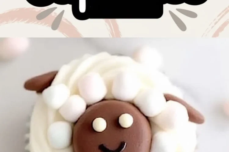 Overhead view of sheep-themed cupcakes with piped white frosting and chocolate sheep faces, detailed with candy eyes and fondant ears, surrounded by mini marshmallow “wool.” Creative spring cupcake idea for themed dessert tables and holiday baking.