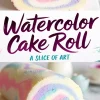 A close-up of a pastel watercolor cake roll with a swirl pattern of pink, blue, yellow, and purple. The smooth sponge exterior is dusted with powdered sugar. A text overlay reads “Watercolor Cake Roll - A Slice of Art.”